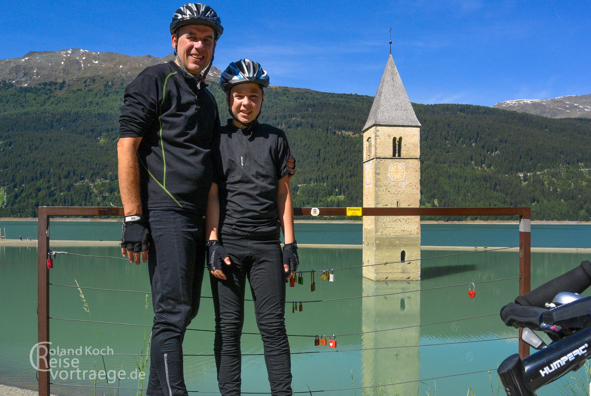 with children by bike over the Alps, Via Claudia Augusta, sunken church tower in Reschensee